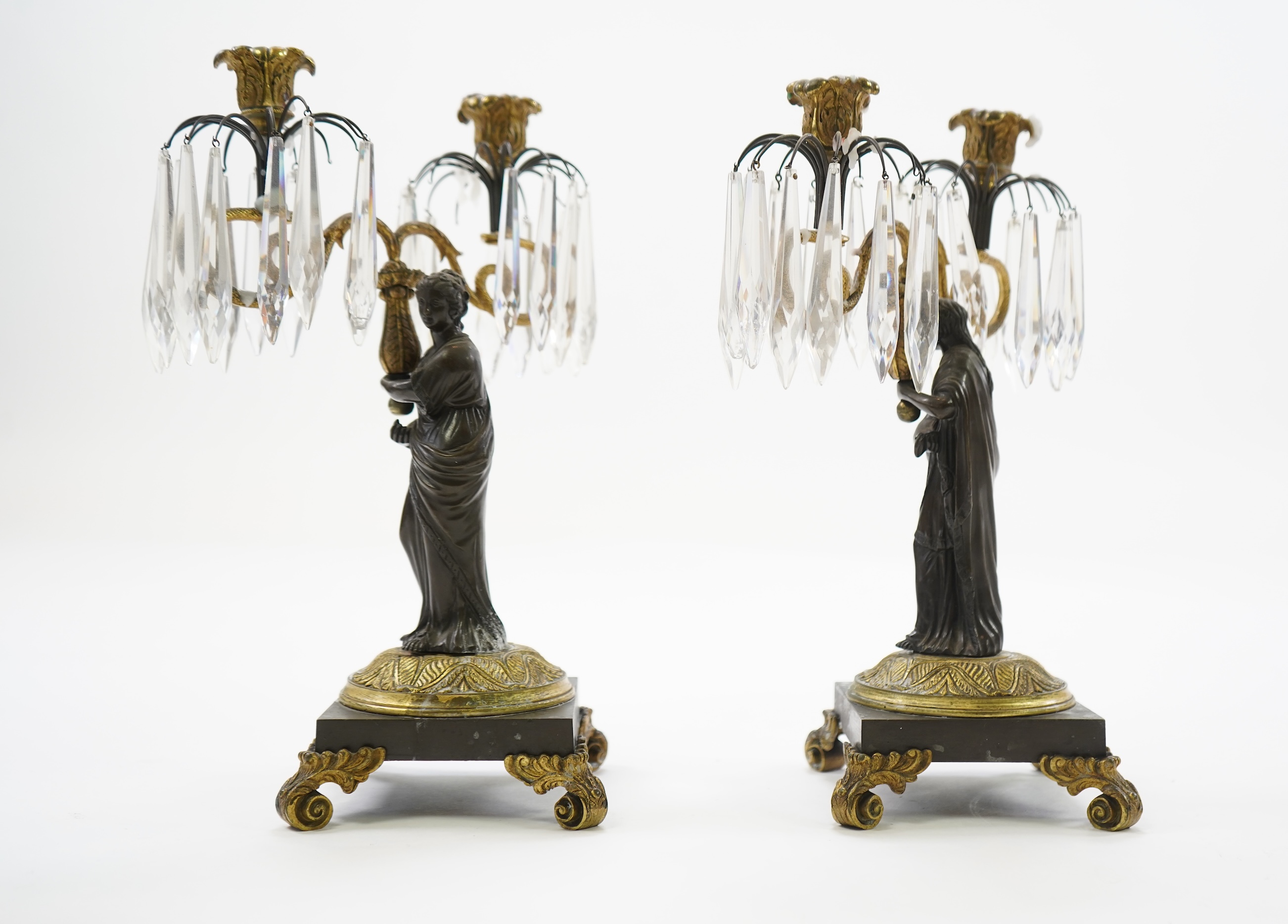 After Mathurin Moreau. A pair of mid 19th century bronze and gilt bronze two branch candelabra